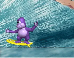BonziBuddy balancing on a yellow surfboard as a large ocean wave rises behind him.